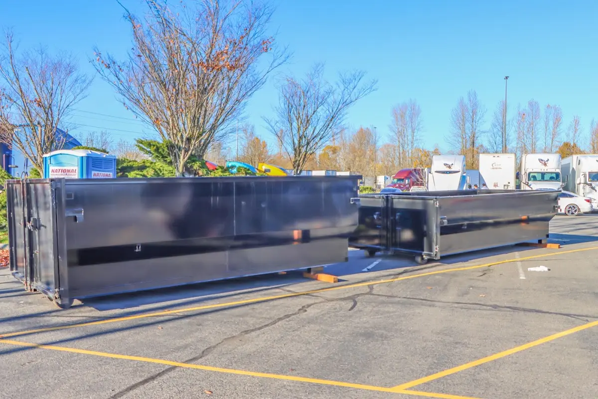 Professional dumpster rental service with roll-off container on residential driveway in Strawberry